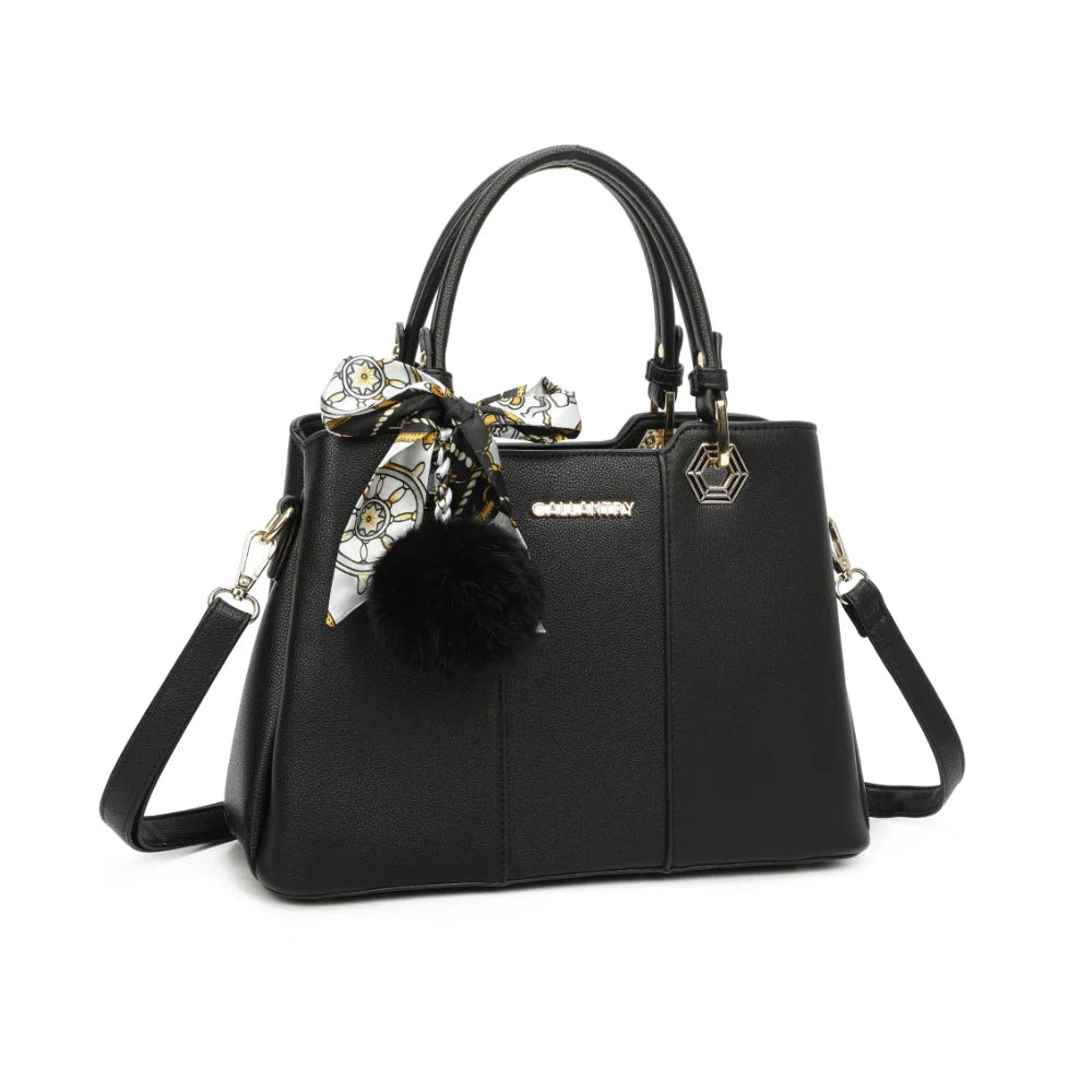 Fiora Pop noir vu de trois quarts : silhouette structurée, quincaillerie dorée hexagonale et pompon – réf. M-9354-3