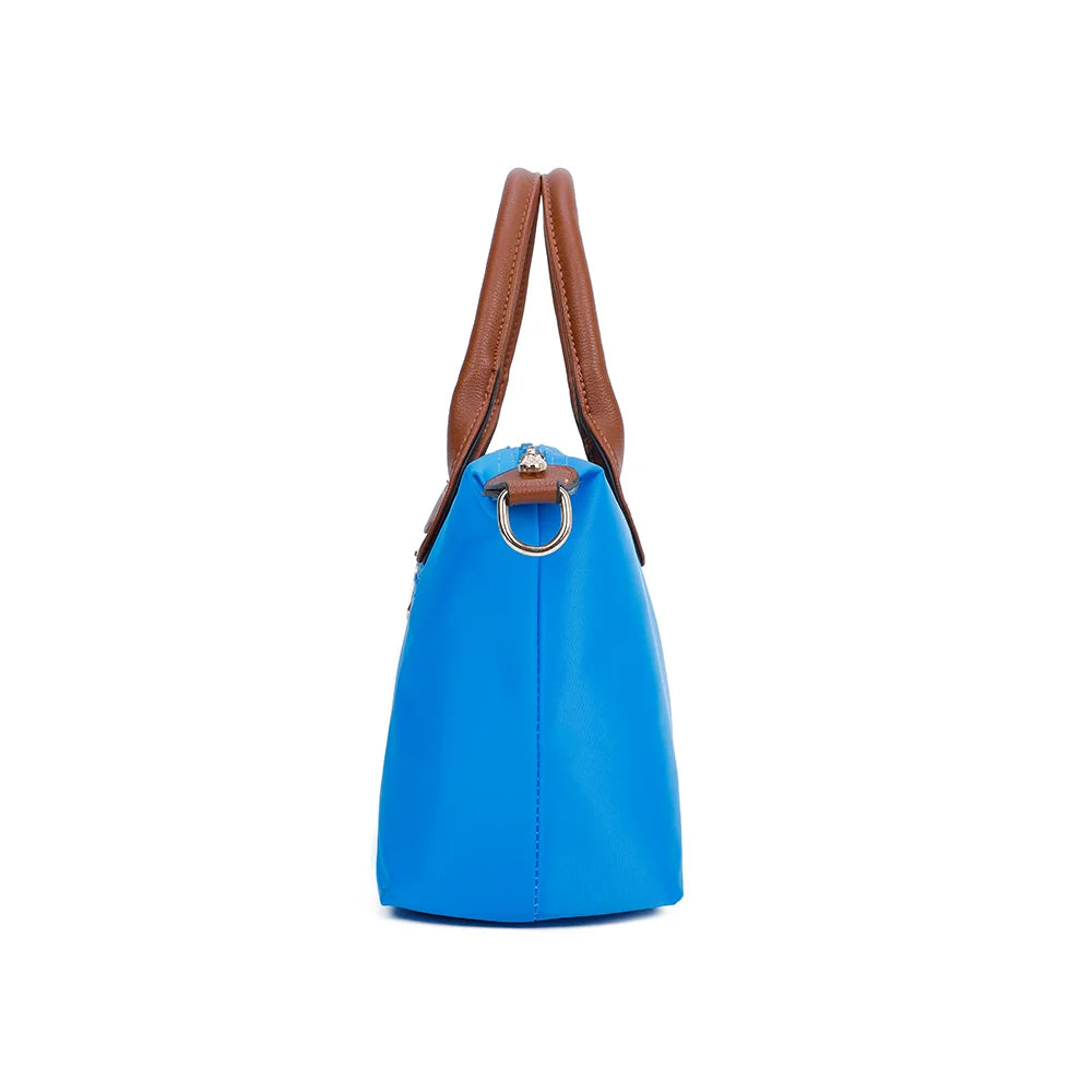 Profil de La Balade bleu electrique : patte latérale en simili cuir et anneau doré pour la bandoulière – réf. Z-01