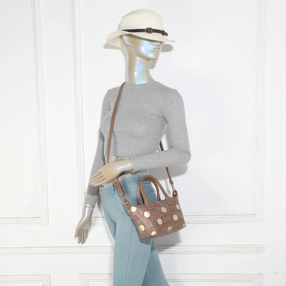 Petit sac à main Le Polka taupe foncé porté par une femme, à la main ou avec sa bandoulière amovible – réf. Z-05-10