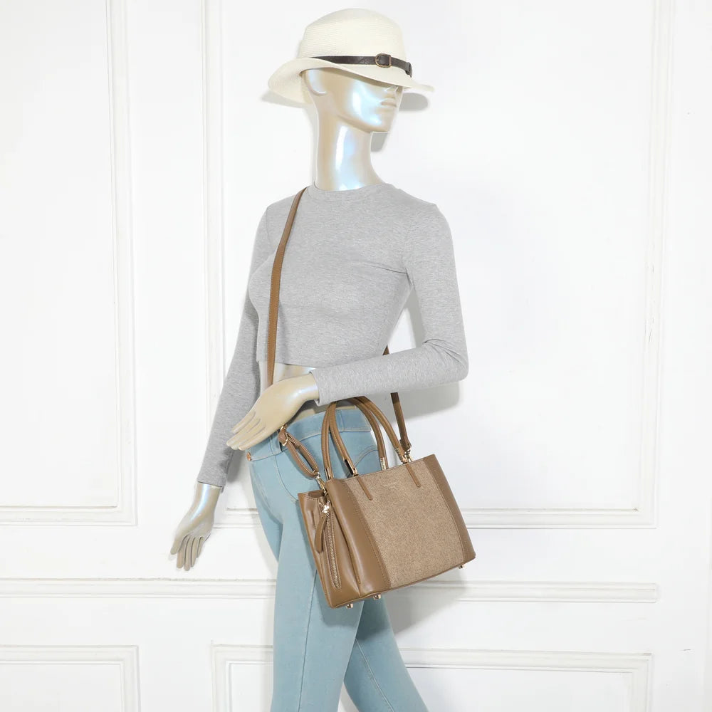 Le Valdora taupe foncé porté par une femme, à la main ou en bandoulière grâce à sa sangle amovible – réf. G-7513