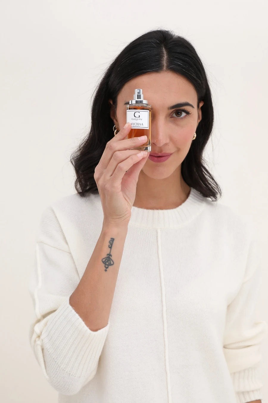 Femme tenant le flacon d'eau de parfum Aychaa de Gallantry Paris à la main