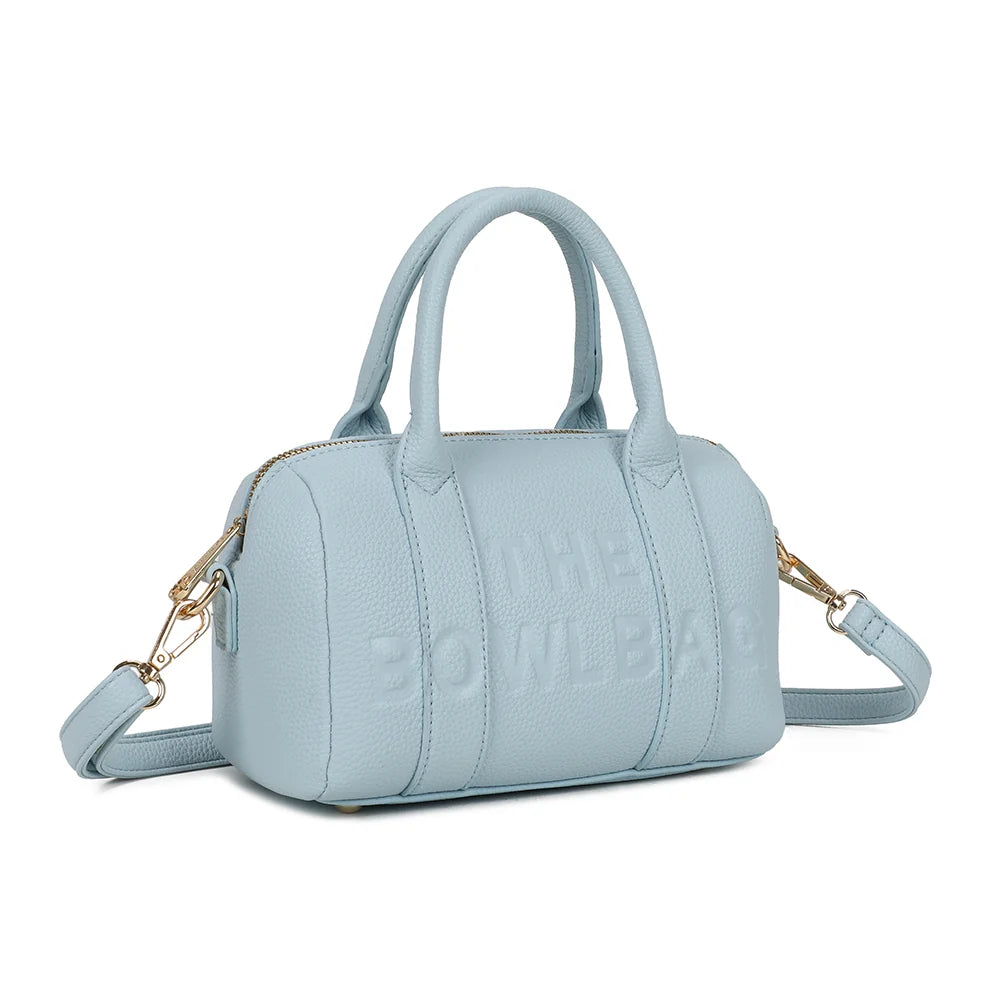 Bowlbag mini bleu pastel de trois quarts : silhouette arrondie de sac bowling et fermeture éclair dorée – réf. R-1995