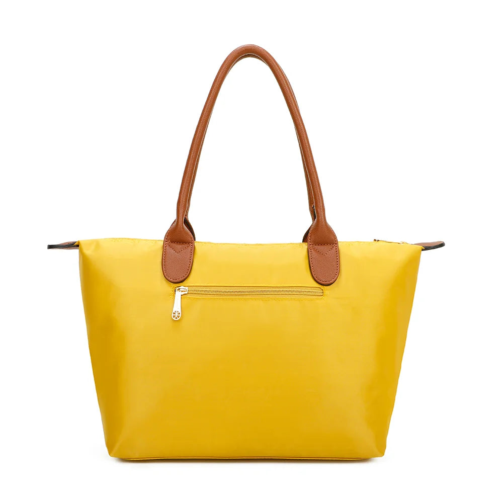 Dos de La Balade Medium jaune : nylon uni et anses marron surpiquées cousues sur le haut du sac – réf. Z-03