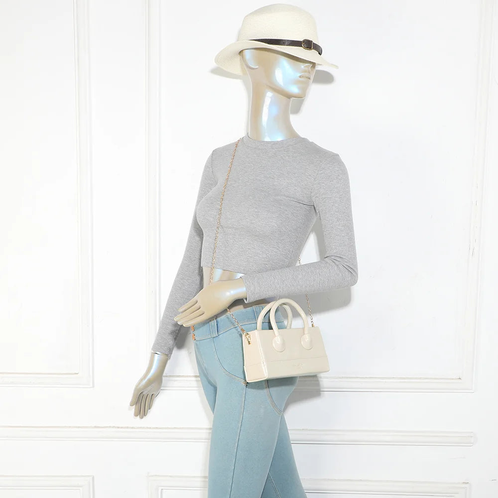 Petit sac femme La Mona beige porté, anses arrondies à la main ou chaîne dorée à l’épaule – réf. YL-26025