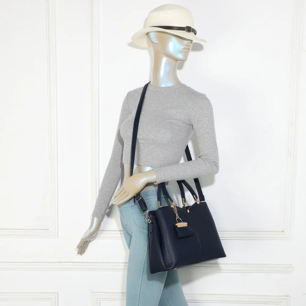 Sac à main femme La Vérone bleu foncé porté à la main, charm doré bien visible – réf. M-9130-1
