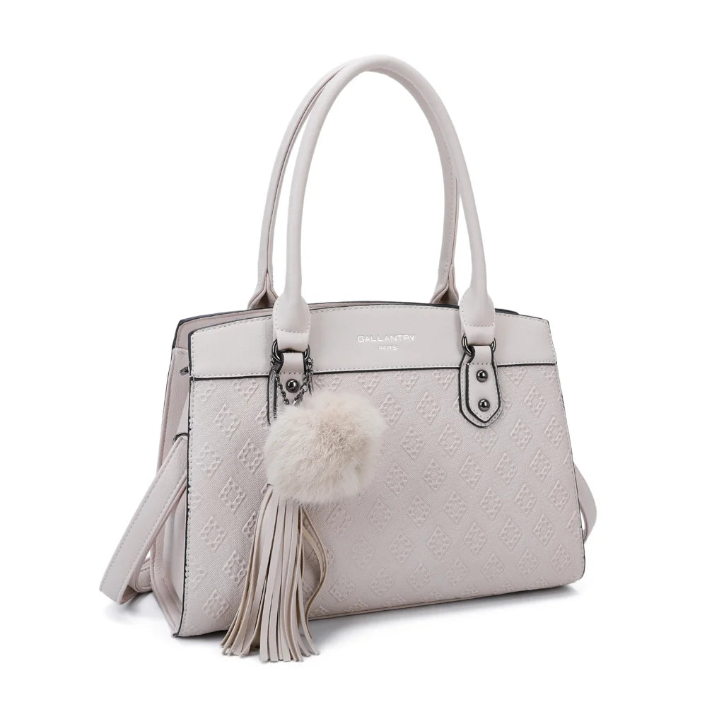 Le Diane beige vu de trois quarts : silhouette structurée, deux longues anses et pompon à pampille – réf. R-1501