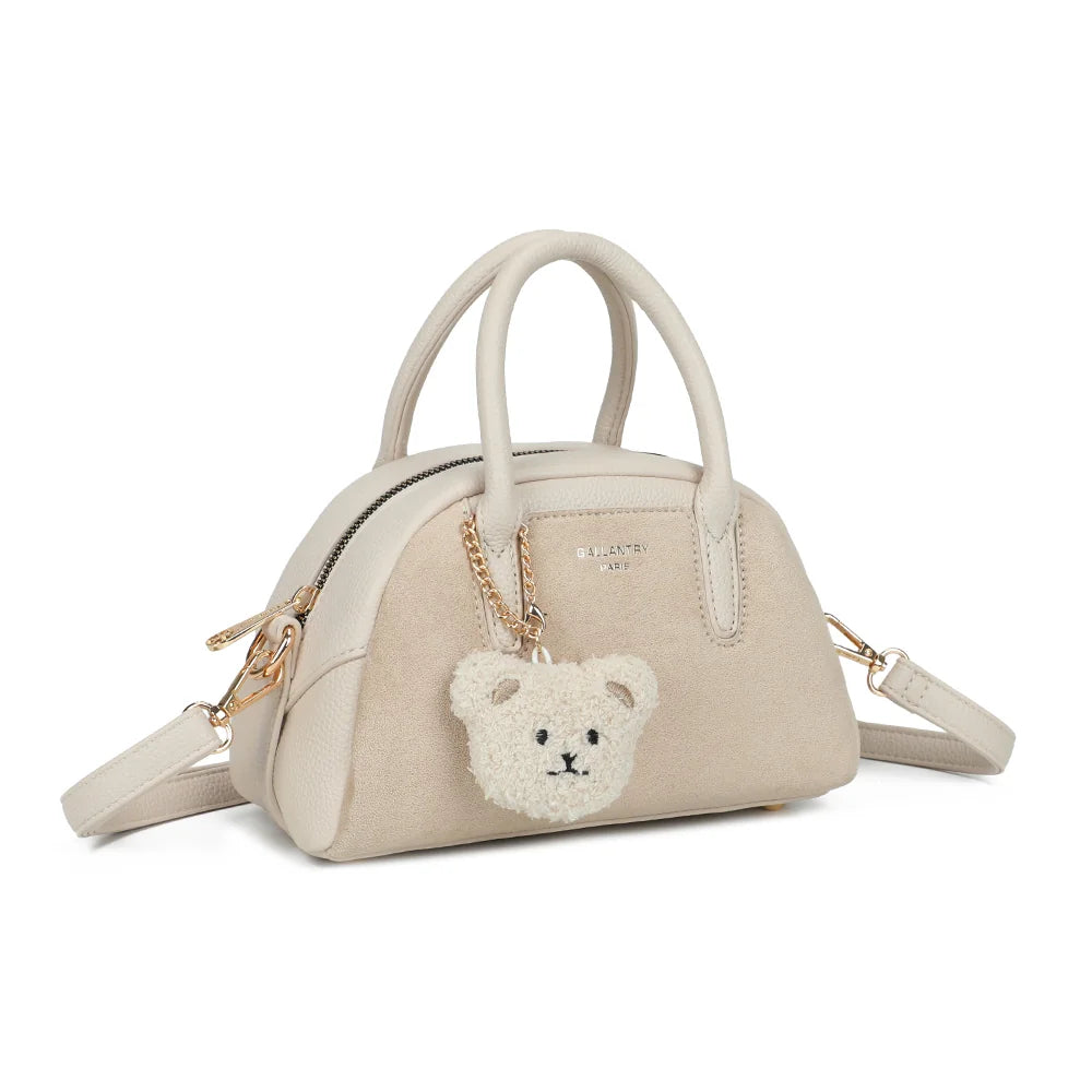Le Mistral beige de trois quarts : côtés arrondis en simili cuir grainé et anneaux dorés pour la bandoulière – réf. R-2070