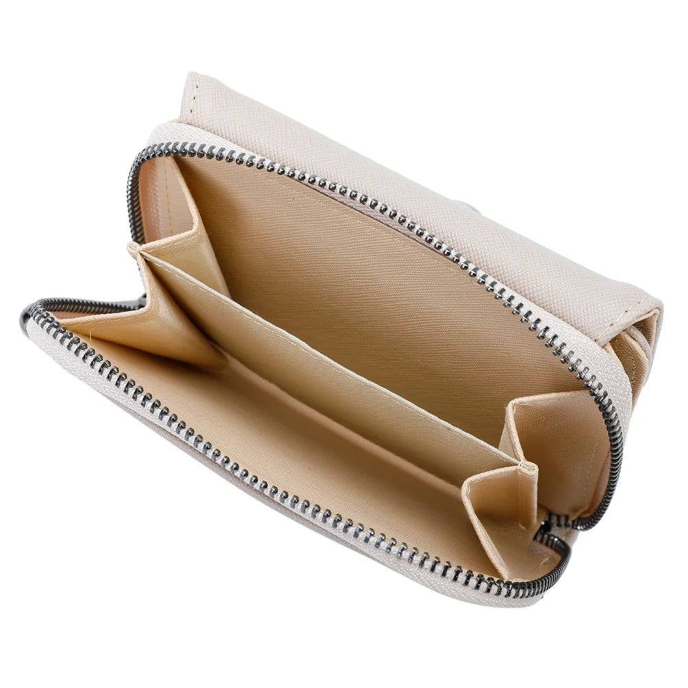 Intérieur du Petit Complice champagne ouvert : compartiments en accordéon pour cartes, billets et pièces – réf. L-29-1