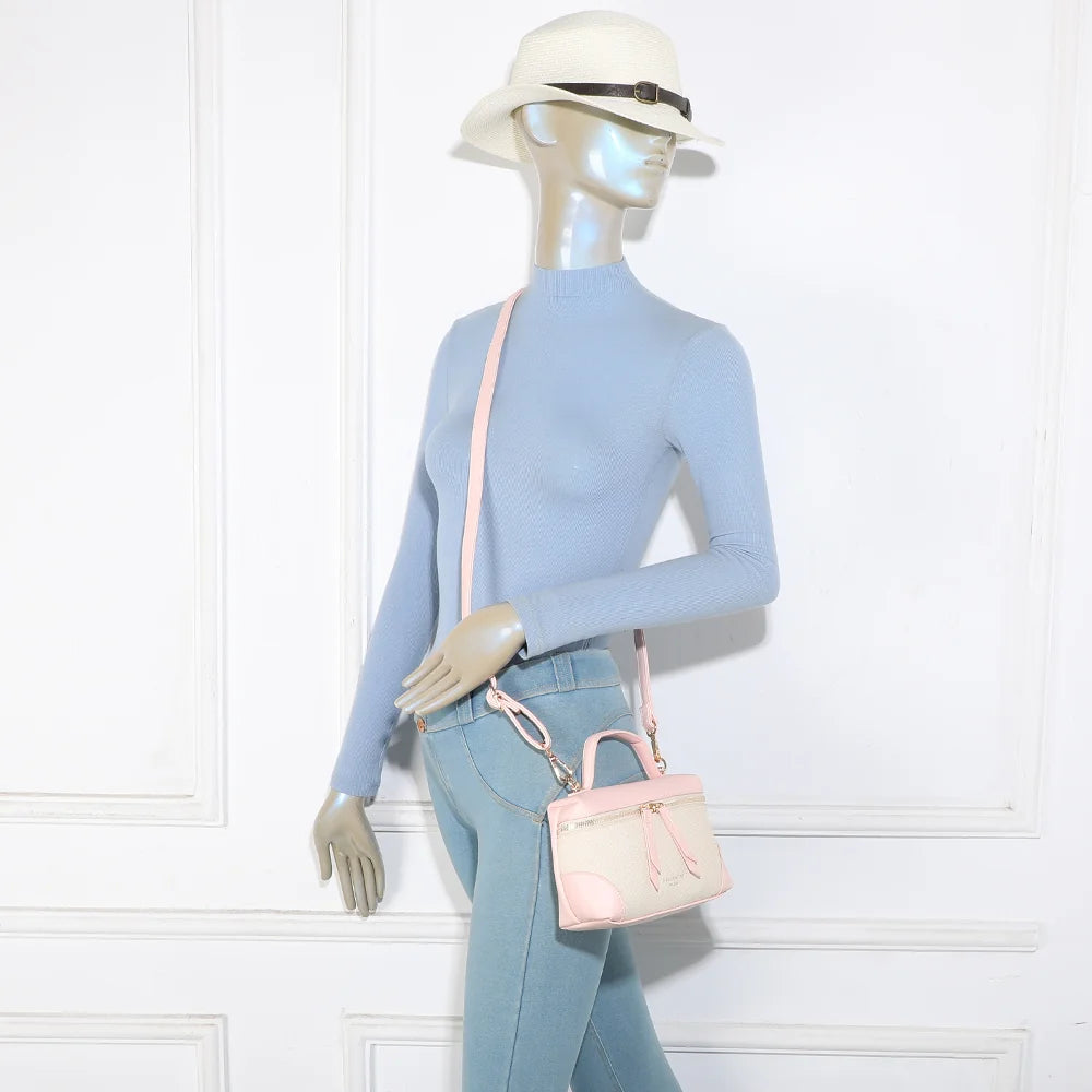 Sac Moka beige/rose porté par une femme, à la main ou en bandoulière grâce à sa sangle amovible – réf. KJ-62091