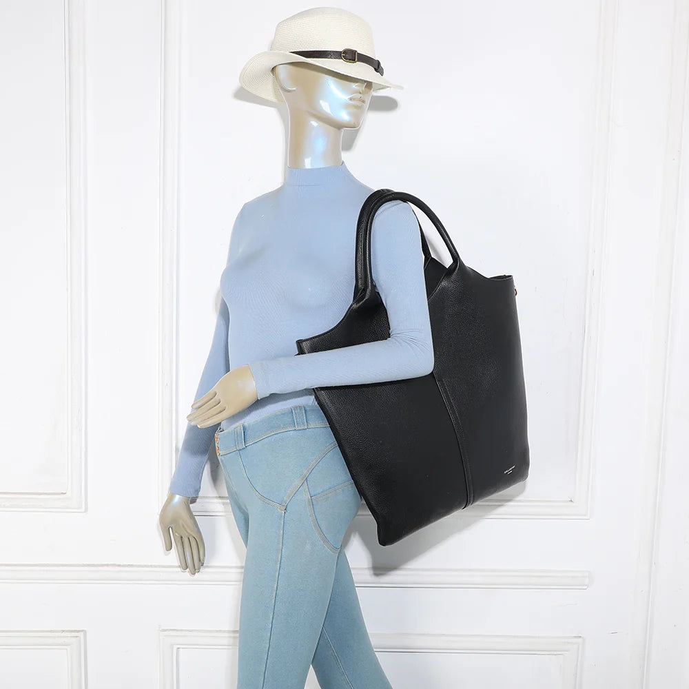 Sac Naéline noir porté par une femme, à la main ou avec la bandoulière amovible – réf. R-2017-1