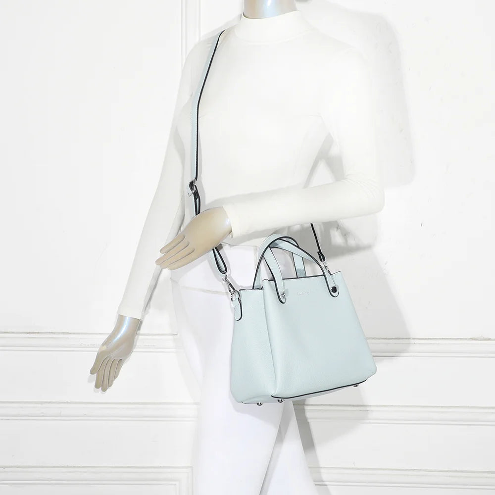 Sac Noa bleu pastel porté par une femme, à la main ou avec sa bandoulière amovible – réf. DQ-8700